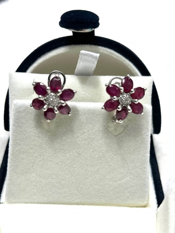 Beautiful natural ruby and white sapphire flower earrings displayed in a jewelry box.