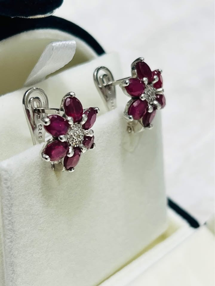 Side view of ruby and white sapphire flower earrings, showing S925 hallmark.