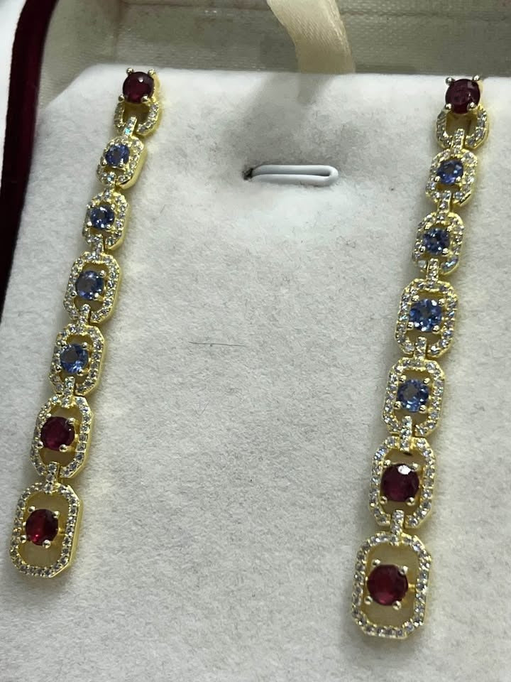 Fancy sterling silver earrings with natural rubies and tanzanite stones, gold vermeil finish.
