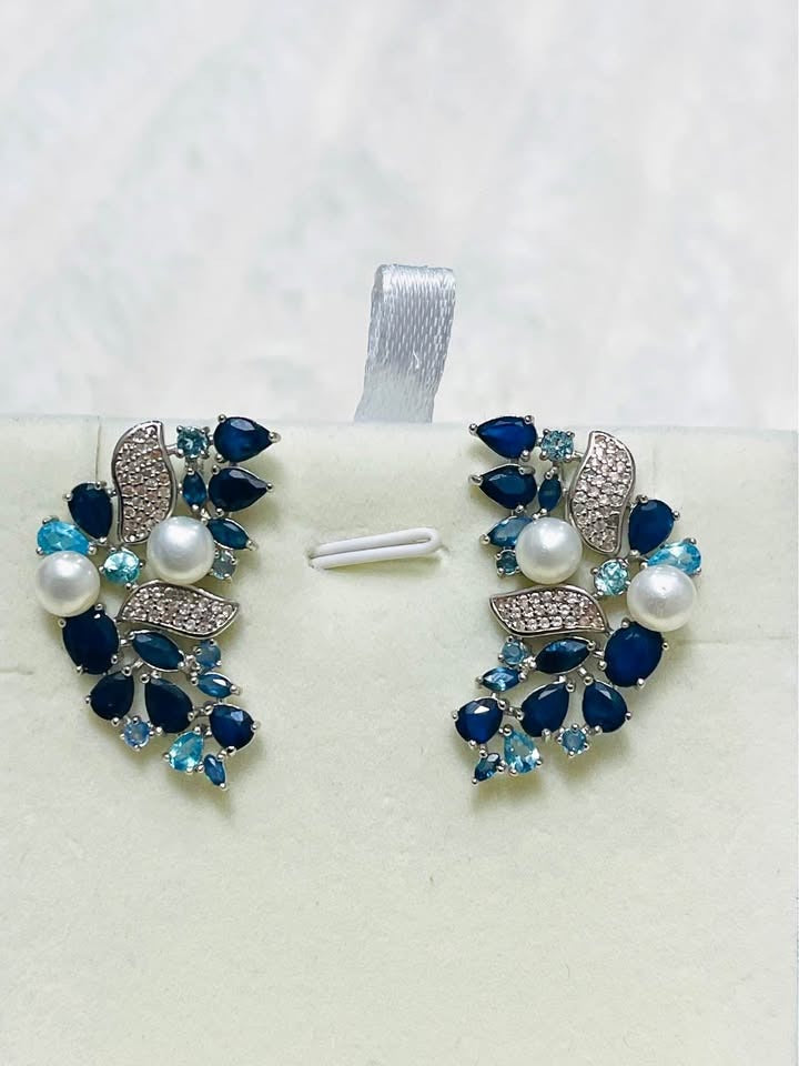 Stunning sterling silver earrings with a combination of sapphires, topaz, and pearls, accented with white topaz.