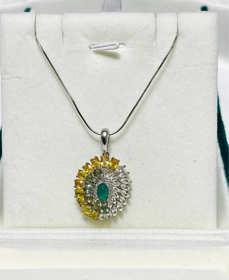  A natural sterling silver necklace with an agate, sapphire, and topaz pendant, shown on a white display stand.