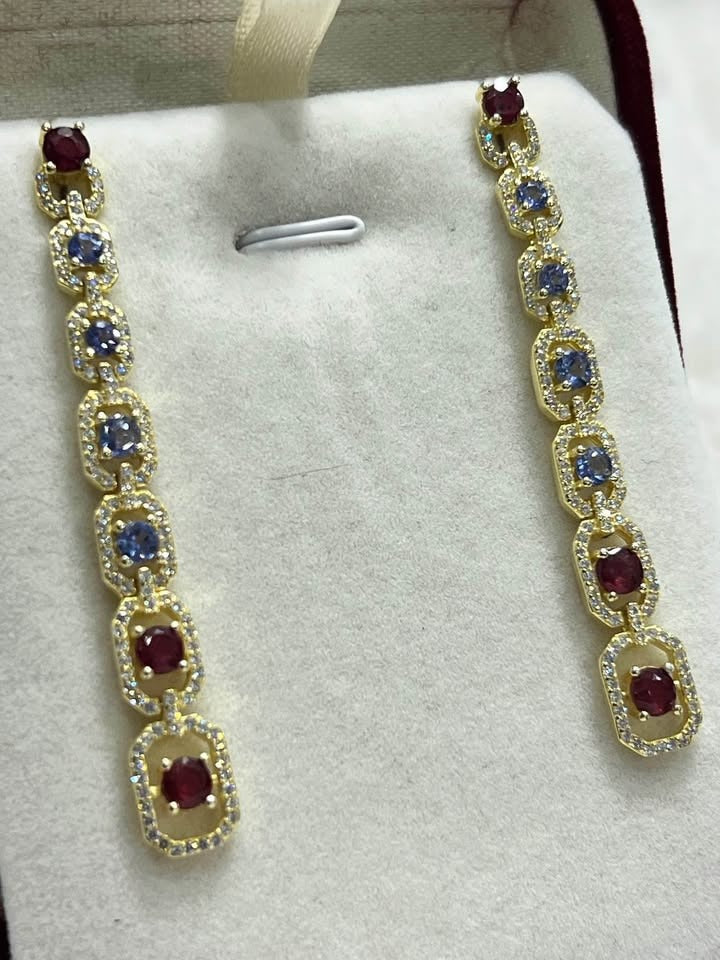Sterling silver drop earrings with alternating natural ruby and tanzanite gemstones, elegant design