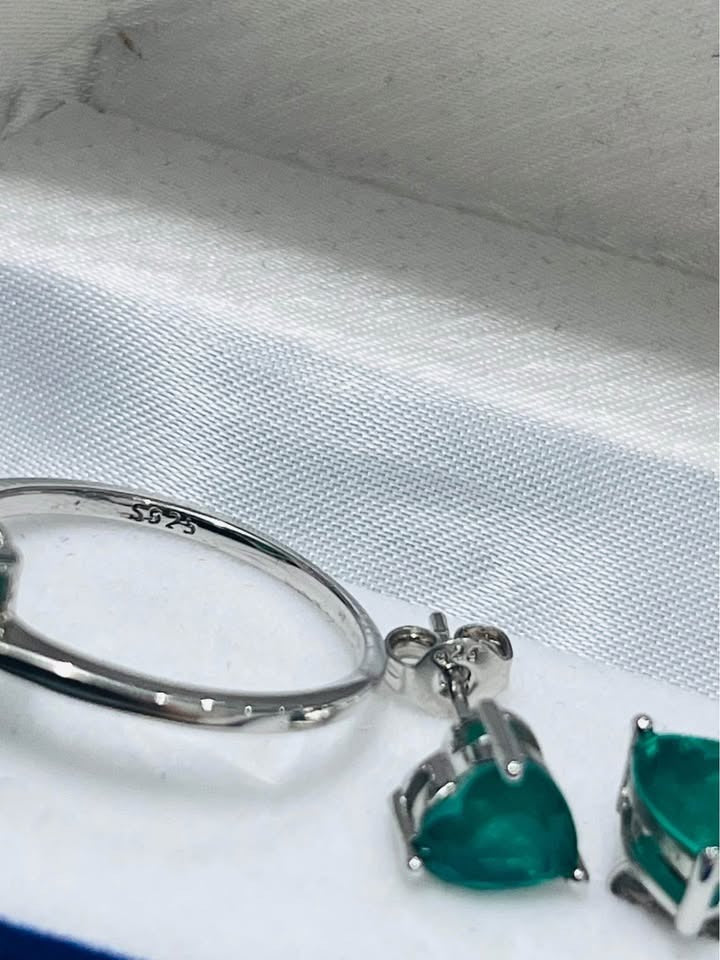 Close-up of sterling silver (S925 stamped) dainty Zambian emerald ring and earring post.