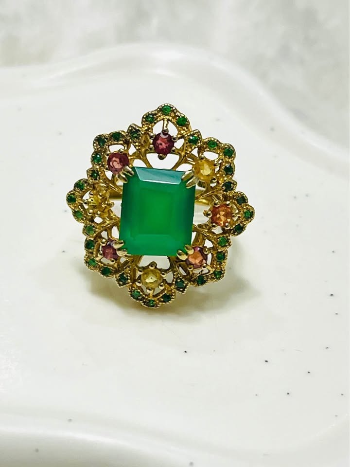 Stunning natural stone ring with a central emerald cut green agate, accented with colorful sapphires and diopside.
