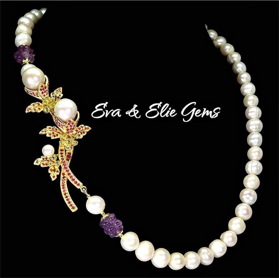 Exquisite South Sea Pearl necklace with natural rubies & amethyst, featuring a vibrant floral-inspired golden centerpiece.