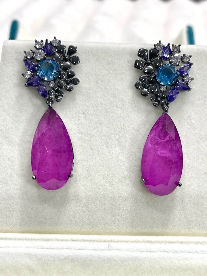 Pair of Paraiba tourmaline and sterling silver rhodium-plated earrings, vibrant and elegant.