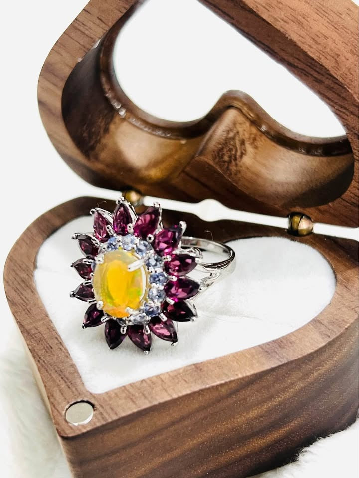 A unique flower-design ring in 925 silver, showcasing natural rubellite, tanzanite, and a bright fire opal.
