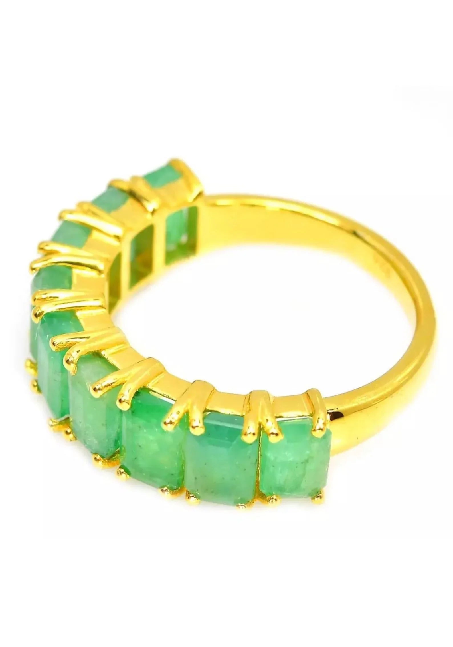 Zambian emerald flower ring held gently in a hand, emphasizing its exquisite craftsmanship and size.