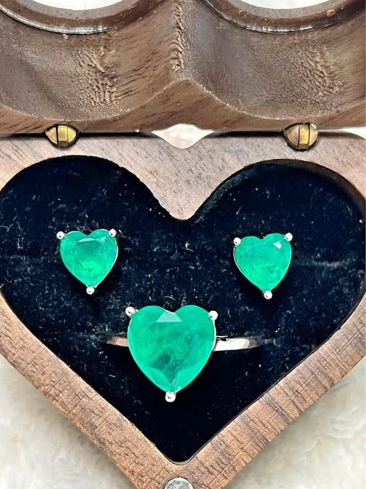 Dainty Zambian emerald heart earrings and matching ring in sterling silver, displayed in wooden box.