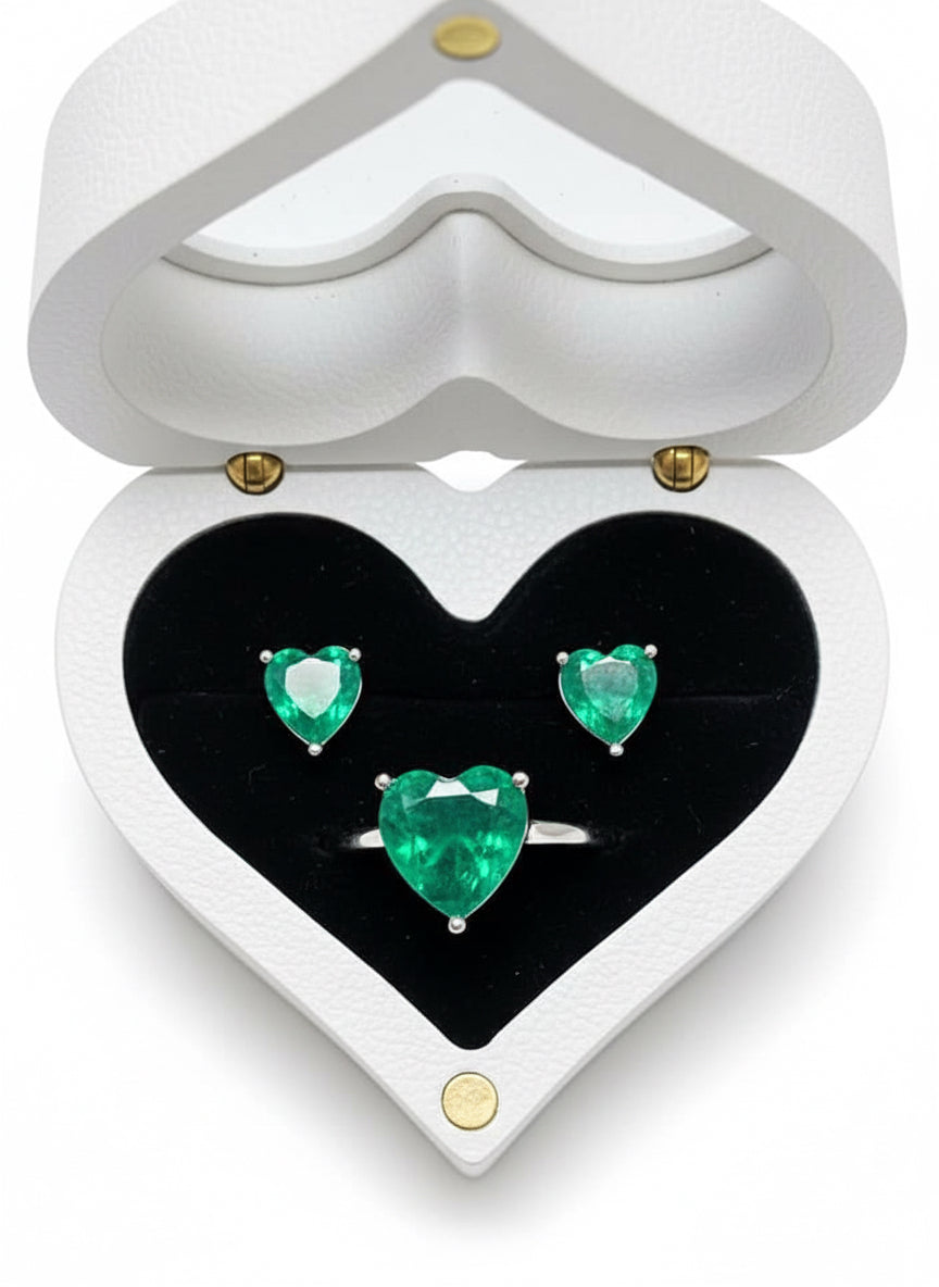  Top view of dainty Zambian emerald heart earrings and ring in a heart-shaped wooden box.